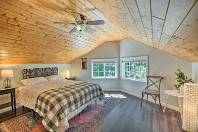 a bedroom with a bed with a wooden ceiling at 1 Mi to Jenkinson Lake Apples Chalet with Deck in Pollock Pines