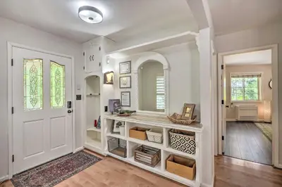 a home hallway with a white door and a mirror at 1 Mi to Jenkinson Lake Apples Chalet with Deck in Pollock Pines