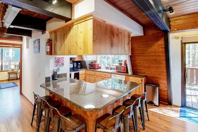 a kitchen with a large wooden table and chairs at Chapel Grove in Tahoe City