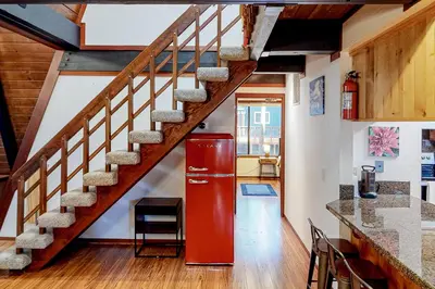 a red refrigerator in a kitchen with a staircase at Chapel Grove in Tahoe City
