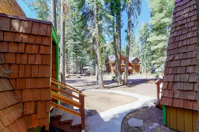 a wooden house with a porch and a forest at Chapel Grove in Tahoe City