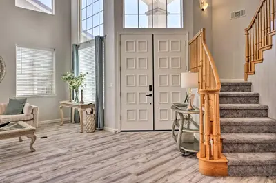 a living room with a staircase and a door at Family-Friendly Modesto Home with Grill and Yard in Modesto