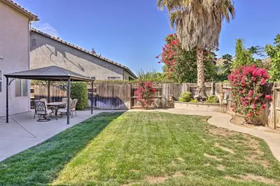 a backyard with a table and a gazebo at Family-Friendly Modesto Home with Grill and Yard in Modesto