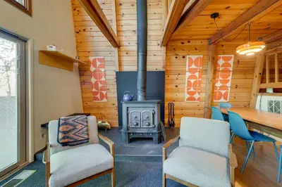 a living room with a fireplace and a table and chairs at Charming Pinecrest Cabin with Private Deck in Strawberry