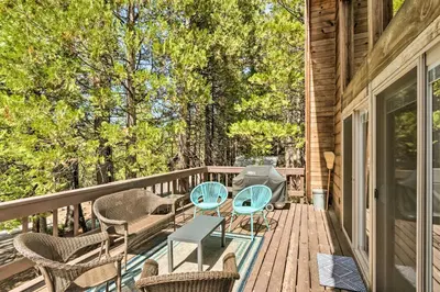 a deck with chairs and a grill on a house at Charming Pinecrest Cabin with Private Deck in Strawberry