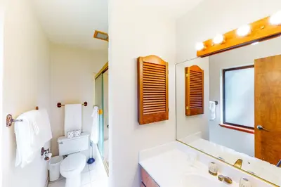 a bathroom with a sink and a toilet and a mirror at Tahoe Enchantment in Zephyr Cove