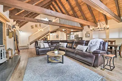 a living room with a leather couch and a table at 2 Mi to Tahoe Donner Ski Resort Forest-View Haven in Truckee