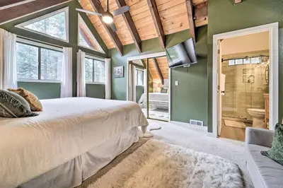 a bedroom with a large bed and a tv at 2 Mi to Tahoe Donner Ski Resort Forest-View Haven in Truckee