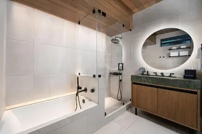 a bathroom with a tub and a shower and a sink at Desolation Hotel in South Lake Tahoe
