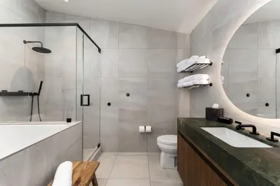 a bathroom with a tub and a sink and a toilet at Desolation Hotel in South Lake Tahoe