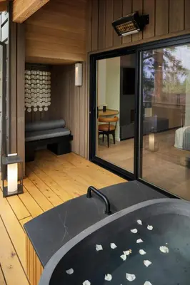 a bathroom with a tub and a room with a table at Desolation Hotel in South Lake Tahoe