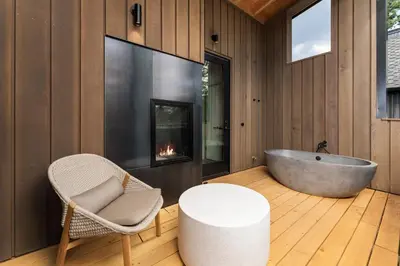 a bathroom with a tub and a chair and a table at Desolation Hotel in South Lake Tahoe