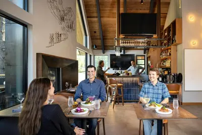 a group of people sitting at tables in a restaurant at Desolation Hotel in South Lake Tahoe