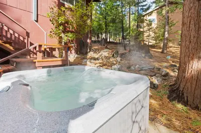 a jacuzzi tub in the backyard of a house at HotTub PingPong Arcade Billiard Pets AC Piano BBQ Art - by SharpCat in Twain Harte