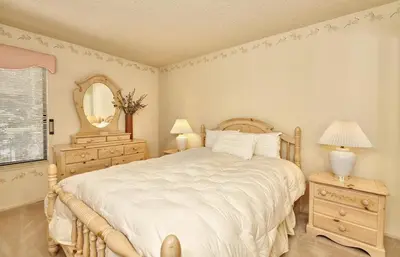 a bedroom with a large bed and a mirror at St Anton Condos #83 condo in Mammoth Lakes