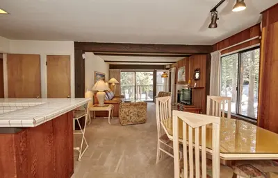 a kitchen and living room with a table and chairs at St Anton Condos #83 condo in Mammoth Lakes
