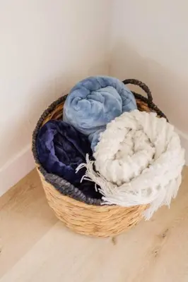 a basket filled with towels sitting on a floor at Gateway Retreat: Short Drive to the Sequoias in Exeter