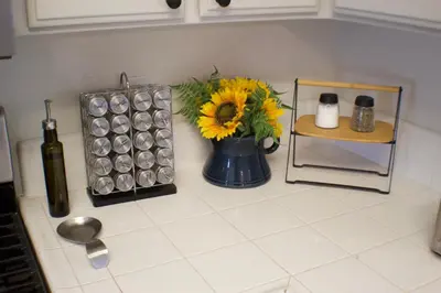 a kitchen counter with a vase with a sunflower on it at Gateway Retreat: Short Drive to the Sequoias in Exeter