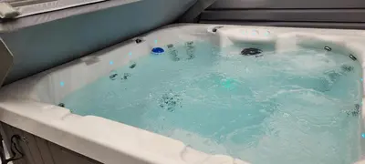 a bath tub filled with blue water in at Lakeside Hotel room #5 in Kings Beach in Kings Beach