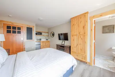 a bedroom with a large white bed and a television at Lakeside Hotel room #5 in Kings Beach in Kings Beach