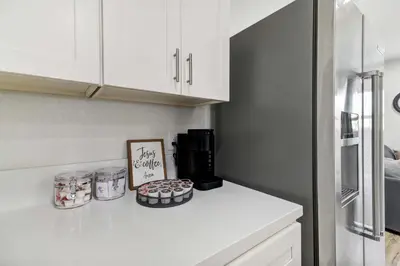 a kitchen with white cabinets and cupcakes on a counter at Country Charmer Single Story Cottage Pet Friendly in Loomis