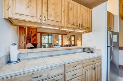 a kitchen with wooden cabinets and a counter top at Silver Strike Sanctuary in Truckee