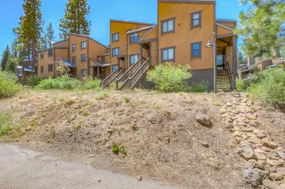 a row of apartment buildings on a dirt hill at Silver Strike Sanctuary in Truckee