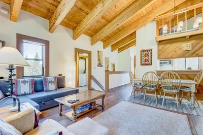 a living room with a blue couch and a table at Silver Strike Sanctuary in Truckee