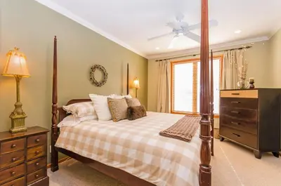 a bedroom with a bed and a dresser and a window at Snowcreek V 984 in Mammoth Lakes