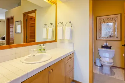 a bathroom with a sink and a toilet and a mirror at Snowcreek V 984 in Mammoth Lakes