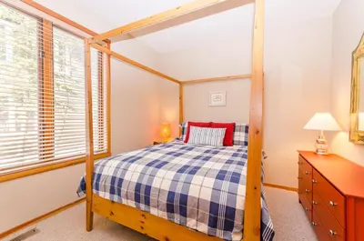 a bedroom with a canopy bed and a dresser at Snowcreek V 984 in Mammoth Lakes