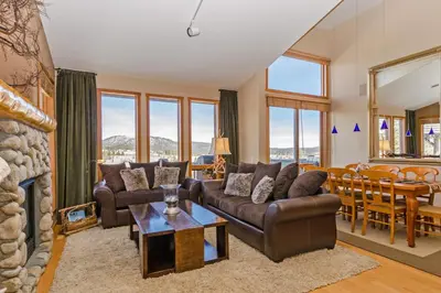 a living room with a couch and a table at Snowcreek V 984 in Mammoth Lakes