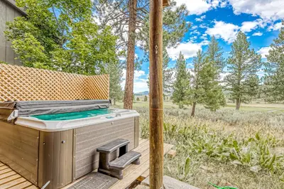 a barbecue on a deck with a view of a field at Basque in Nature in Truckee