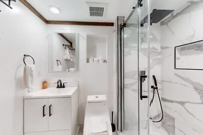 a bathroom with a shower and a toilet and a sink at Basque in Nature in Truckee