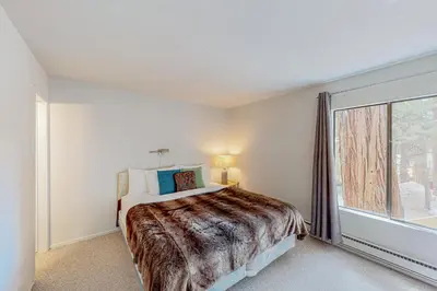 a bedroom with a bed and a large window at Falcon Nest in Incline Village