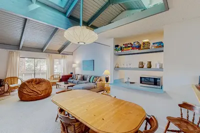 a living room with a table and a couch at Falcon Nest in Incline Village