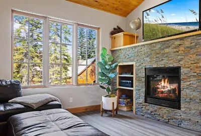 a living room with a fireplace and a tv at Modern Condo - EV Plug In - SM 301 in Bear Valley