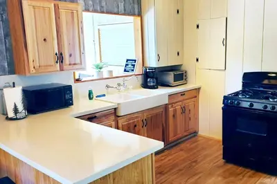 a kitchen with a sink and a stove at Redwood Retreat, Mountains, Adventure and Nature in Ponderosa