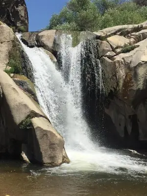 a waterfall on the side of a large rock at Redwood Retreat, Mountains, Adventure and Nature in Ponderosa