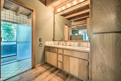 a bathroom with two sinks and a large window at Hot Tub and Ski Shuttle Northstar Resort House in Truckee