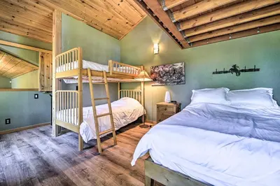 a bedroom with two bunk beds and a wooden ceiling at Hot Tub and Ski Shuttle Northstar Resort House in Truckee