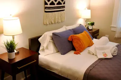 a bedroom with a bed with colorful pillows on it at 738 E Yale in Fresno