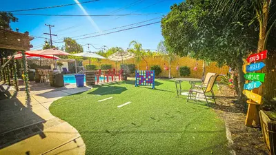 a yard with a playground with a table and chairs at Tropical Paradise in Fresno