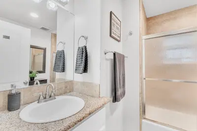 a bathroom with a sink and a shower at Tropical Paradise in Fresno