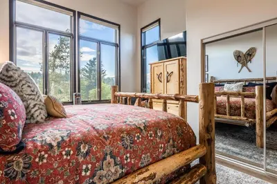 a bedroom with a bed and large windows at Great Views Fully Renovated Luxury 4 Bedroom 3 Full Bathrooms and Half Bath Snowcreek 732 Phase V in Mammoth Lakes