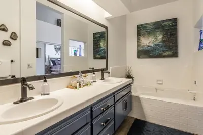 a bathroom with two sinks and a tub and a mirror at Great Views Fully Renovated Luxury 4 Bedroom 3 Full Bathrooms and Half Bath Snowcreek 732 Phase V in Mammoth Lakes