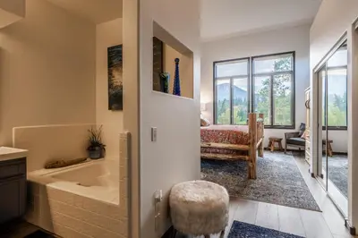 a bathroom with a tub and a chair in it at Great Views Fully Renovated Luxury 4 Bedroom 3 Full Bathrooms and Half Bath Snowcreek 732 Phase V in Mammoth Lakes