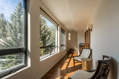 a hallway with two chairs and large windows at Walk to Lift Updated 2 Bedroom 2 and a Half Bathrooms 1849 Condos 209 Steps to Canyon Lodge Sleeps 6 in Mammoth Lakes