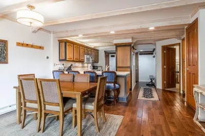 a kitchen and dining room with a wooden table and chairs at Walk to Lift Updated 2 Bedroom 2 and a Half Bathrooms 1849 Condos 209 Steps to Canyon Lodge Sleeps 6 in Mammoth Lakes