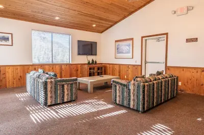 a living room with two chairs and a tv at Walk to Lift Updated 2 Bedroom 2 and a Half Bathrooms 1849 Condos 209 Steps to Canyon Lodge Sleeps 6 in Mammoth Lakes